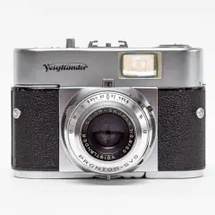 A vintage silver and black Voigtländer camera with a prominent lens and viewfinder.