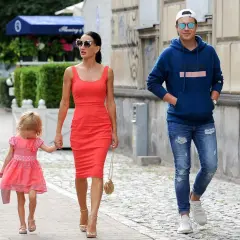 Justyna Steczkowska z córką i synem spacerują ulicą. Piosenkarka ma na sobie czerwoną sukienkę, a jej dzieci są ubrane w kolorowe ubrania.
