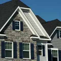 Modern homes with dark asphalt shingles, showcasing their durability and aesthetic appeal.