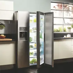 Cuisine moderne avec réfrigérateur ouvert, rempli de produits frais. L'inconvénient froid statique est évité grâce à une organisation optimale.