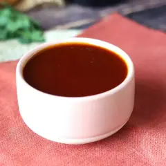 Un bol de sauce barbecue maison, parfaite pour accompagner vos grillades. Une recette simple pour un goût authentique.
