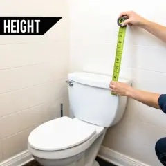 Measuring for optimal grab bar installation height next to a toilet.