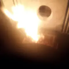 Flammes vives dans un poêle Piazzetta, peut-être un problème de tirage. La chaleur intense illumine l'intérieur.