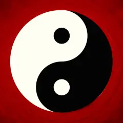 Il simbolo Yin e Yang, principio della filosofia orientale, su sfondo rosso sfumato.