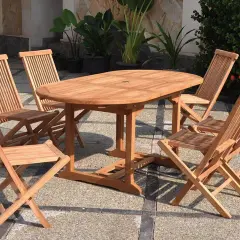 Ensemble de jardin en teck matière, table ovale et chaises pliantes, parfait pour profiter du soleil.