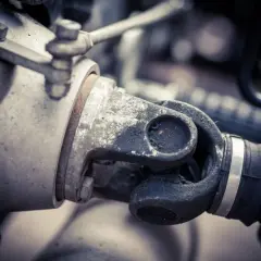 Primer plano del cardan de una moto, mostrando su junta universal y el eje de transmisión, esencial para la potencia.