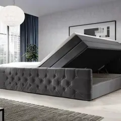 Modernes Boxspringbett mit Stauraum. Der Bezug ist aus grauem Samt, die Matratze ist hochgeklappt. Vielleicht ist das Boxspringbett zu hart?