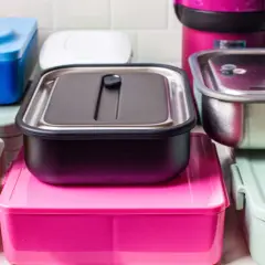 A colorful assortment of various types of bento boxes, including stainless steel, plastic, and stacked designs, ready for a delicious meal.