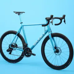 A bright blue road bike with black wheels and handlebars. The word "SPOOKY" is visible on the frame, hinting at these spooky bikes.