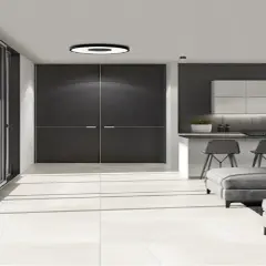 Luminaria circular de plafon 40 cm ilumina un salón moderno con puertas correderas, cocina y sofás grises.