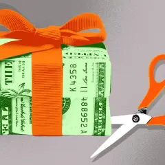 A gift-wrapped stack of money with scissors poised to cut. This symbolizes the potential changes to the gift tax limit in 2026.