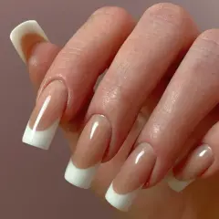 Dłoń z perfekcyjnym manicure hybrydowym w stylu francuskim.