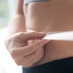 Misura della vita con metro, per capire quante calorie bisogna bruciare al giorno per raggiungere i propri obiettivi di benessere.