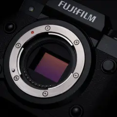 Zbliżenie na sensor aparatu Fujifilm XH2S. Widoczny metalowy pierścień mocowania obiektywu i złote styki.