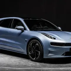 Błękitny Zeekr 001 na obrotowej platformie, gotowy na podbój dróg w Polsce. Futurystyczny design i elektryczna moc.