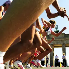 Biegaczki startują do maratonu pod Bramą Brandenburską. Słychać hasła dopingujące biegaczy, którzy walczą o zwycięstwo.