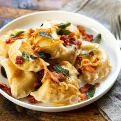 Pyszne pierogi z boczkiem i cebulką. Zastanawiasz się, ile gotować pierogi, by były idealne? Te wyglądają na gotowe!