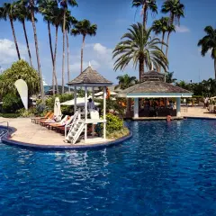 Tropikalny raj z basenem, palmami i barem przy plaży. Idealne miejsce na wakacje ultra all inclusive.