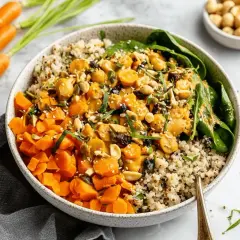 Bunter Quinoa-Bowl mit Karottenwürfeln, Kichererbsen und Nüssen. Ein leckeres Beispiel für Karotten Rezepte.
