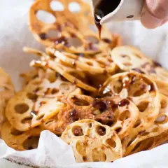 Crispy lotus root chips drizzled with a dark sauce, a simple and delicious addition to your easy Japanese recipes.