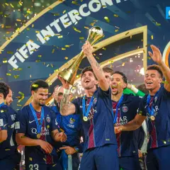 Piłkarze PSG świętują z pucharem, sypie się złoty konfetti. To ich aktualny skład, pełen radości po zwycięstwie.