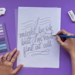 A hand draws "I might be ok but I'm not fine at all" in elegant cursive script.