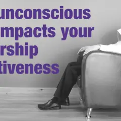 A man sits with a newspaper over his head, symbolizing how unconscious bias coaching can improve leadership effectiveness.