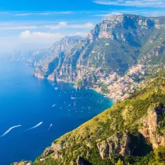 A stunning view of the Amalfi Coast, where the Path of the Gods winds through dramatic cliffs overlooking the azure sea.