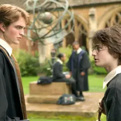 Robert Pattinson jako Cedric Diggory rozmawia z Harrym Potterem na dziedzińcu Hogwartu.