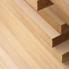 Stack of solid mdf boards, showing their layered construction and fine texture.