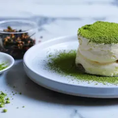 Dolci veloci al matcha: soffice crema e polvere verde brillante su un piatto, con ingredienti a lato.