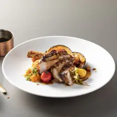 Une délicieuse escalope de veau grillée, servie avec une purée de courge, des légumes rôtis et une sauce savoureuse.