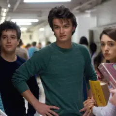 A group of teens in a hallway, featuring the iconic Stranger Things color palette of muted blues, greens, and pinks.