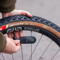 Checking how much air in bike tire. The gauge reads 27.3 PSI on a Peyote XC Race tire.