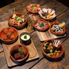 Tapas co to? Różnorodne przekąski: klopsiki w sosie, oliwki, ser, wędliny, ryby i mięso na patyczkach. Idealne na wspólne biesiadowanie.