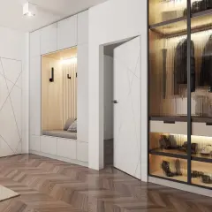 Nowoczesny hol z ukrytymi w ścianie drzwiami, siedziskiem i przeszkloną szafą.