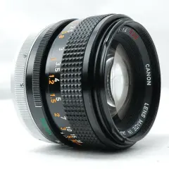A Canon 50mm f/1.4 SSC lens, a contender for the best Canon FD lens, showcasing its aperture and focus rings.