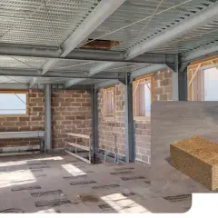 Costruzione in corso con struttura metallica e pareti in laterizio termico. In primo piano, blocchi di laterizio termico.