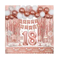 Decoración para una celebración de 18 cumpleaños con globos, guirnaldas y un mantel rosa dorado.