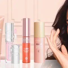 En kvinna med en strålande glow, omgiven av L'Oréal-produkter som True Match Nude, Lumi Glotion och Lumi Le Glow.