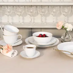 Elegantes schwedisches Porzellan mit goldenen Akzenten, serviert mit Beeren, Kaffee und Gebäck.