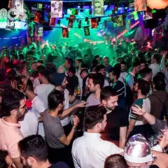Festa vivace in una delle discoteche gay di Madrid, con luci colorate e gente che balla.