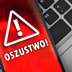 Ostrzeżenie na ekranie telefonu: "OSZUSTWO!". Uważaj na oszustwa na OLX, gdy widzisz takie komunikaty.