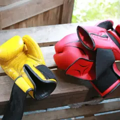 Yellow and red boxing gloves ready for a sparing sport session.