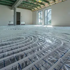 Instalacja ogrzewania podłogowego w nowym domu. Rozłożone rury zapowiadają komfort i niższy koszt ogrzewania.