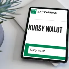 Tablet z aplikacją BNP Paribas wyświetla "Kursy walut". Obok stoi doniczka z rośliną.
