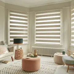 Modern living room with striped roller blinds, offering a stylish way to choose best window coverings.