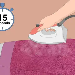 Ironing pink polyester velvet with steam for 15 seconds.