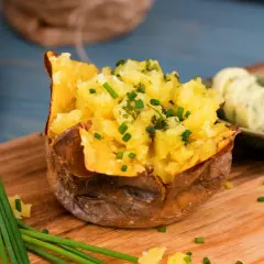 En fluffig, bakad potatis i micro, toppad med gräslök och serverad med örtsmör. Enkel och god middag!