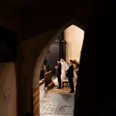 Para dowiedzieć się, jak zostać fotografem ślubnym, warto obserwować takie momenty. Para młoda w kościele, w otoczeniu gości.